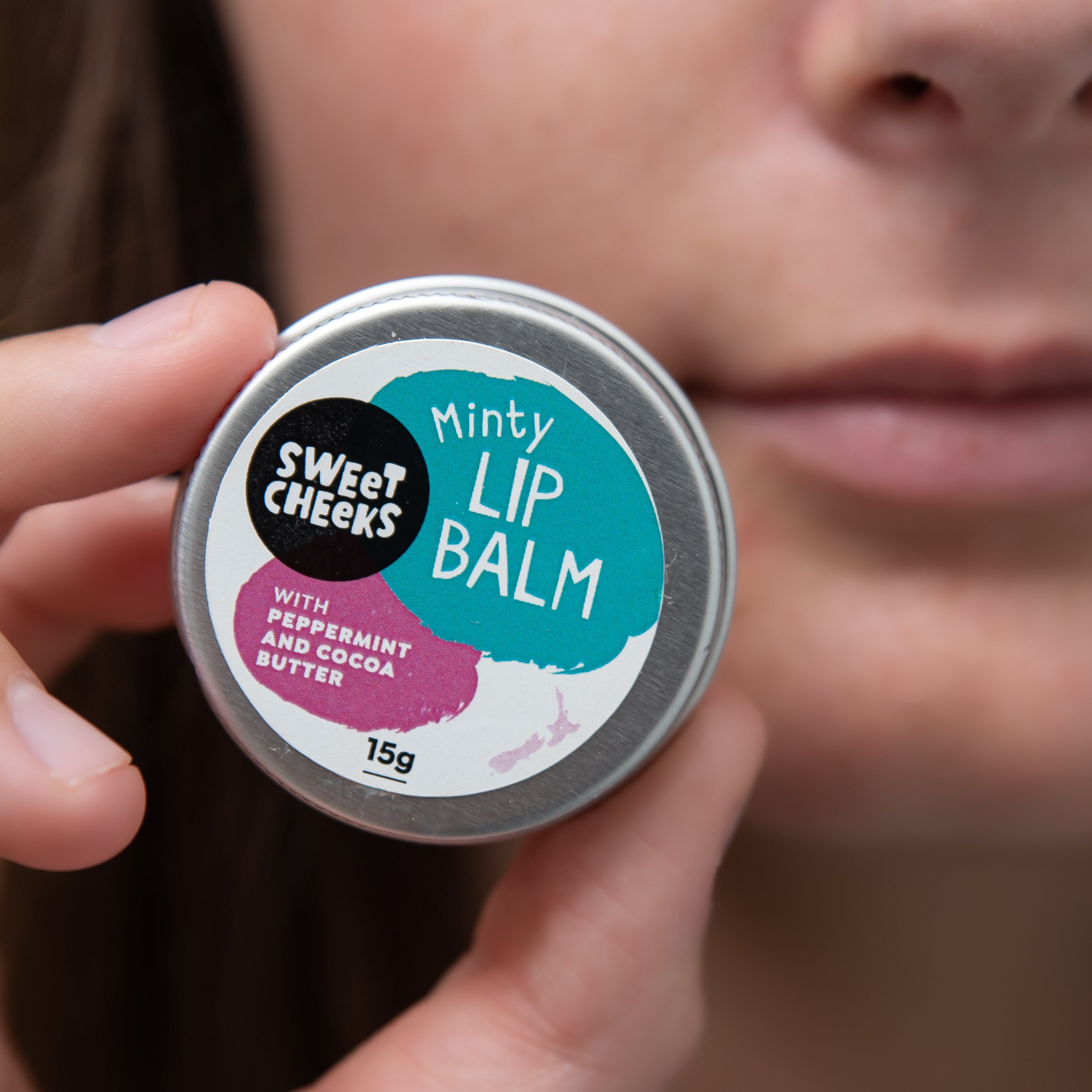 Lip balm with woman holding the tin