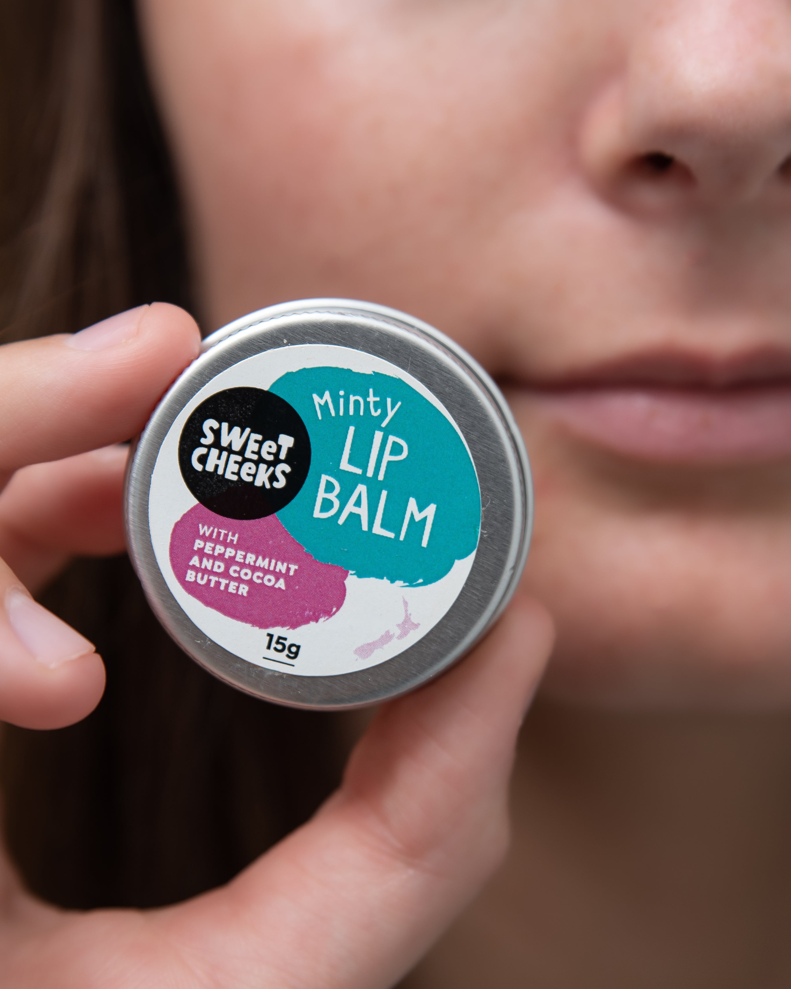 Lip balm with woman holding the tin