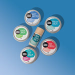 Collection of lip balm tins with colorful labels on a blue background